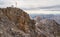 Zugspitze summit with the gold-plated summit cross and three mountaineers in the vicinity of the German Alps