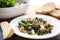 zuppa toscana in white bowl, bread slice resting on edge