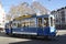 ZÃ¼rich-City: An oldtimer tram is curving around Stadelhofen train station