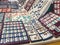 Â«Madrid,SpainÂ»; 11-11-2018: Market stall with earrings and pendants of different colors and shapes and people buying