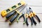 à¹‡Hardware tools, equipment used for repair and maintenance work in general technicians isolated on wooden background closeup.