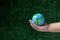 à¹‡World Earth Day and ESG and co2 concept. Human hand holding young earth and plant in ecology and environment sustainable