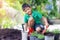 â€‹Asianâ€‹ boy planting tree on pots,Child is planting spring flowers tree on pots in the garden