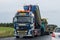 Ã„ngelholm, Sweden - September 3, 2020: Trucks and machinery is laying new asphalt as cars drives by