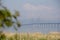 The Ã–resund bridge looks almost blue in the foggy summer morning by the coast of MalmÃ¶, Sweden