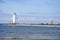 ÅšwinoujÅ›cie, Poland - June 2018: Windmill, lighthouse on the breakwater