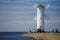 ÅšwinoujÅ›cie, Poland - June 2018: Windmill, lighthouse on the breakwater