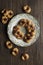 ‘Brutti ma buoni’: homemade rustic biscuits. Some ingredients are: eggs; sugar; flour; butter, and chocolate, on wooden table