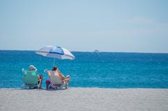 2 People In Beach Chairs On The Sand On A Beach In Florida Stock Photo 2 People In Beach Chairs On The Sand On A Beach In Florida Stock Photo