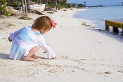A Baby Girl On The Beach Stock Photo