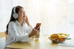 A Beautiful Asian Woman Is Listening To Music Happily In Her Home Stock Photography