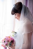 A Chinese Bride Looking At Bouquet Stock Images