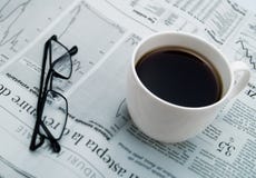 A Cup Of Coffee, Glasses And A Newspaper Royalty Free Stock Images