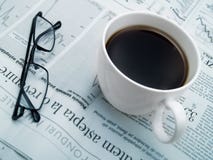 A Cup Of Coffee, Glasses And A Newspaper Stock Photo