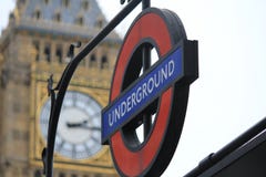 A Famous Logo Of The Underground In London, United Kingdom With Big Ben In The Background Stock Photography
