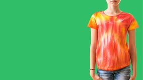 A Girl In A T-shirt With Tie Dye Style In The Right Side Of The Frame On A Green Background. Royalty Free Stock Photography A Girl In A T-shirt With Tie Dye Style In The Right Side Of The Frame On A Green Background. Royalty Free Stock Photography