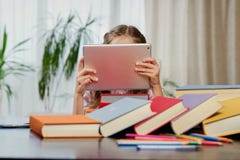 A Girl Looking At The Tablet PC. Stock Photo