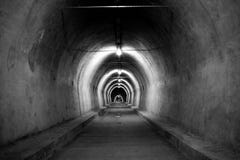 A Long Dirty Tunnel Photographed In Black And White Royalty Free Stock Photo