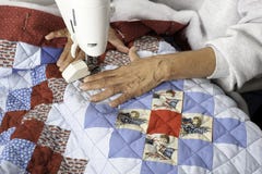 A Quilter Machine Quilting Patriotic Quilt. Stock Photography