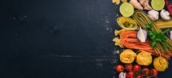 A Set Of Pasta, Noodles, Spaghetti, Tagliatelle, Fettuccine, Farfalle. Italian Cooking, Fresh Vegetables And Spices. Royalty Free Stock Photography A Set Of Pasta, Noodles, Spaghetti, Tagliatelle, Fettuccine, Farfalle. Italian Cooking, Fresh Vegetables And Spices. Royalty Free Stock Photography