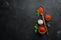 A Set Of Red Spices On A Black Background. Paprika, Chili Pepper. Stock Photo