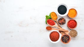 A Set Of Spices And Herbs On A White Wooden Table. Basil, Pepper, Saffron, Spices. Indian Traditional Cuisine. Stock Image A Set Of Spices And Herbs On A White Wooden Table. Basil, Pepper, Saffron, Spices. Indian Traditional Cuisine. Stock Image