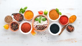 A Set Of Spices And Herbs On A White Wooden Table. Basil, Pepper, Saffron, Spices. Indian Traditional Cuisine. Stock Photography
