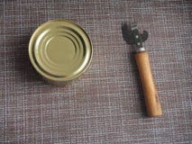 A Tin Can And A Can Opener. The Opening Of The Cans Royalty Free Stock Photo