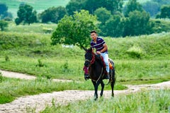 A Young Man Riding Horse On The Meadow Royalty Free Stock Photos