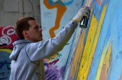 A Young Red-haired Graffiti Artist Paints A New Graffiti On The Wall Stock Photos