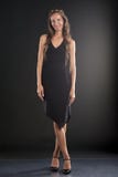 A Young Woman In A Black Dress Stock Photo