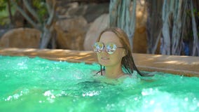 A Young Woman In A Tropical Resort With Hot Springs, Waterfalls And Swimming Pools With Hot Mineral Water. Slowmotion Royalty Free Stock Images A Young Woman In A Tropical Resort With Hot Springs, Waterfalls And Swimming Pools With Hot Mineral Water. Slowmotion Royalty Free Stock Images