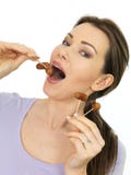 Aantrekkelijke Jonge Vrouw die Mini Cocktail Sausages op Stokken eten Royalty-vrije Stock Foto's Aantrekkelijke Jonge Vrouw die Mini Cocktail Sausages op Stokken eten Royalty-vrije Stock Foto's