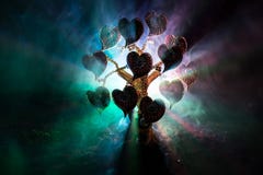 Abstract field with tree and hearts on it behind dark foggy toned sky. Love tree of dreams. Valentine concept background stock images Abstract field with tree and hearts on it behind dark foggy toned sky. Love tree of dreams. Valentine concept background stock images