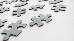 Abstract gray jigsaw puzzle pieces on white background stock photo Abstract gray jigsaw puzzle pieces on white background stock photo