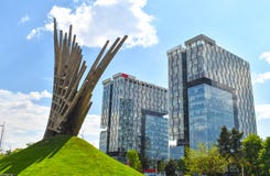 Abstract statue in front of the City Gate Towers, two class A office buildings located in Press Square of Bucharest, capital of stock images Abstract statue in front of the City Gate Towers, two class A office buildings located in Press Square of Bucharest, capital of stock images