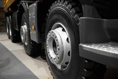 Abstract tipper truck wheels and tires with blured background. Truck wheel rim. Truck chassis exhibit on car Exhibition. Commercia stock images Abstract tipper truck wheels and tires with blured background. Truck wheel rim. Truck chassis exhibit on car Exhibition. Commercia stock images
