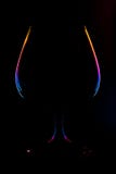 Abstract view on a wine glass silhouette with lighted multi-colored gradient edges on a black background stock image Abstract view on a wine glass silhouette with lighted multi-colored gradient edges on a black background stock image