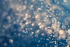 Abstract yellow bokeh of blurry lights background. Soft focus bokeh light effects over a rippled, blue water background. Creative stock image Abstract yellow bokeh of blurry lights background. Soft focus bokeh light effects over a rippled, blue water background. Creative stock image