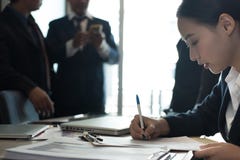 Accord contractuel d'affaires de signe de femme d'affaires la femme écrivent sur p images stock Accord contractuel d'affaires de signe de femme d'affaires la femme écrivent sur p images stock