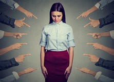 Accusation of guilty person. Sad woman looking down fingers pointing at her stock photography Accusation of guilty person. Sad woman looking down fingers pointing at her stock photography