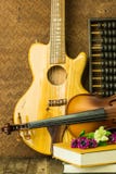 acoustic-guitar-violin-old-steel-background-64629067.jpg