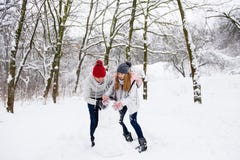 Active couple of teenagers making snowman stock photography Active couple of teenagers making snowman stock photography