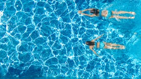 Active Girls In Swimming Pool Water Aerial Drone View From Above, Children Swim, Kids Have Fun On Tropical Family Vacation Royalty Free Stock Photo