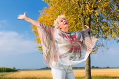Active senior woman feeling free and happy while standing outdoo royalty free stock images Active senior woman feeling free and happy while standing outdoo royalty free stock images