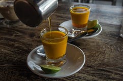 Adding honey to two healthy jamu shots in close-up without hand different perspective Stock Photos Adding honey to two healthy jamu shots in close-up without hand different perspective Stock Photos