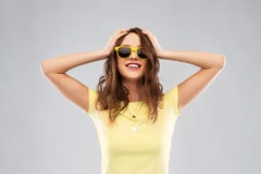 Adolescente dans les lunettes de soleil et le T-shirt jaunes photographie stock Adolescente dans les lunettes de soleil et le T-shirt jaunes photographie stock