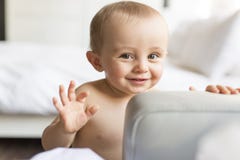Adorable baby boy in the living room with bed on the back royalty free stock images Adorable baby boy in the living room with bed on the back royalty free stock images