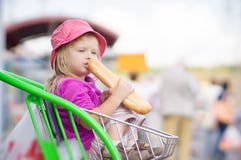 Adorable Baby Eat Long Bread, Sit In Cart Royalty Free Stock Image