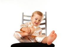 Adorable Baby Girl Sitting On A Chair Stock Image